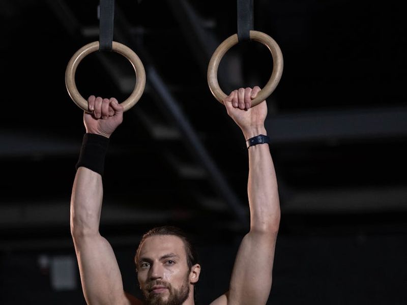 Man focusing on a steady strength movement in a gym.